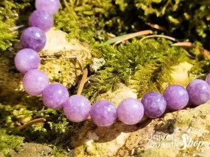 bracelet en lépidolite de qualité supérieur AA posé dans une forêt