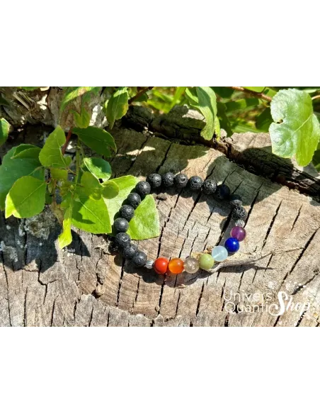 bracelet 7 chakras signification pierre de lave 8mm posé sur une souche d'arbre