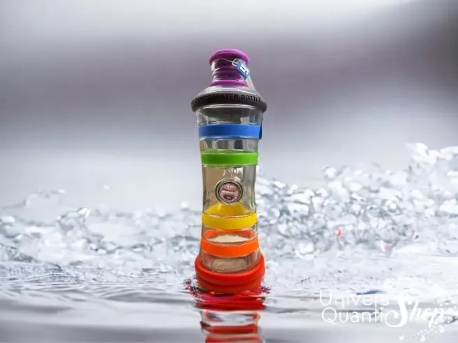 bouteille i9 stimule l'eau, réduit le stress, couleur 7 chakras posé sur de l'eau