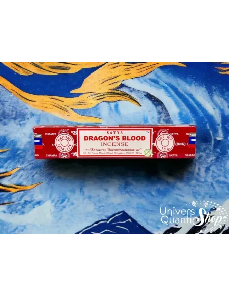 encens roulé à la main en inde, dragon blood satya sang de dragon boite posée sur un fond Hokusai