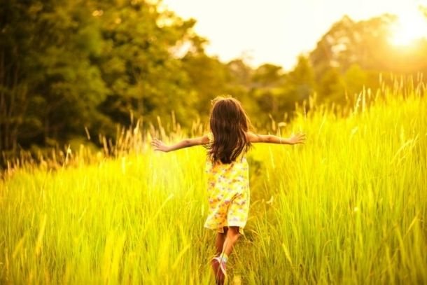 enfant qui court dans un champ avec les bras levés enfant intérieur
